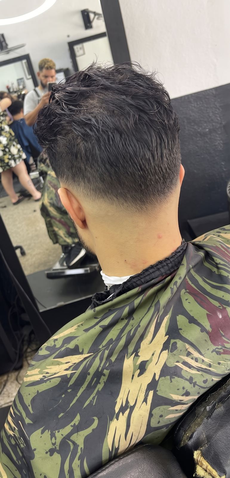 Back view of a dark textured top blended into a clean taper at the nape.
